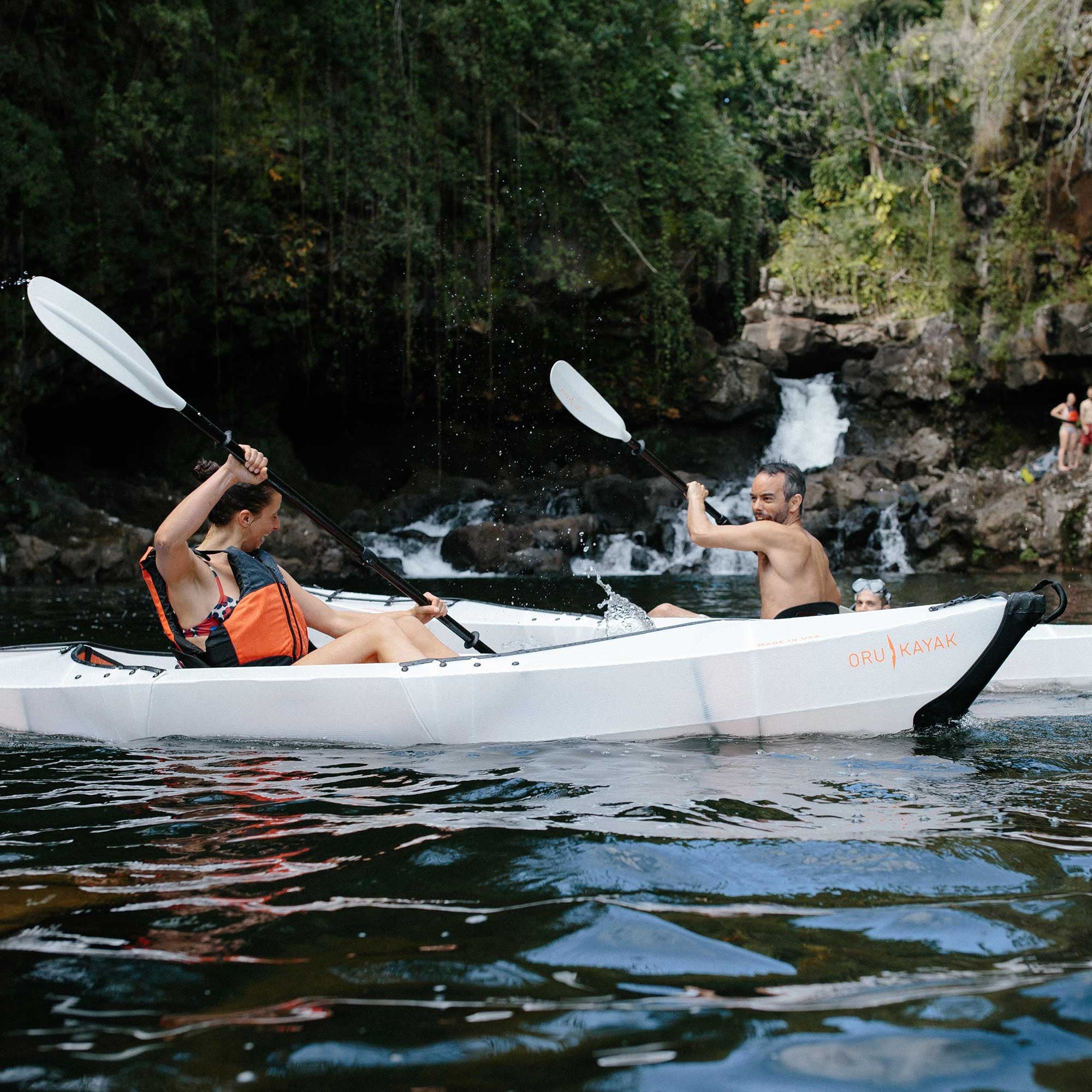 man and woman paddling 