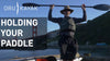 A man holding a paddle