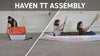 A woman and a man demonstrating how to assemble the kayak