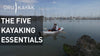A man kayaking close to the boats