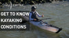 A man kayaked near a cluster of rocks