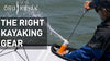 The man tries to get the water off the kayak using an equipment