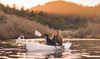 Women kayaking with her black dog